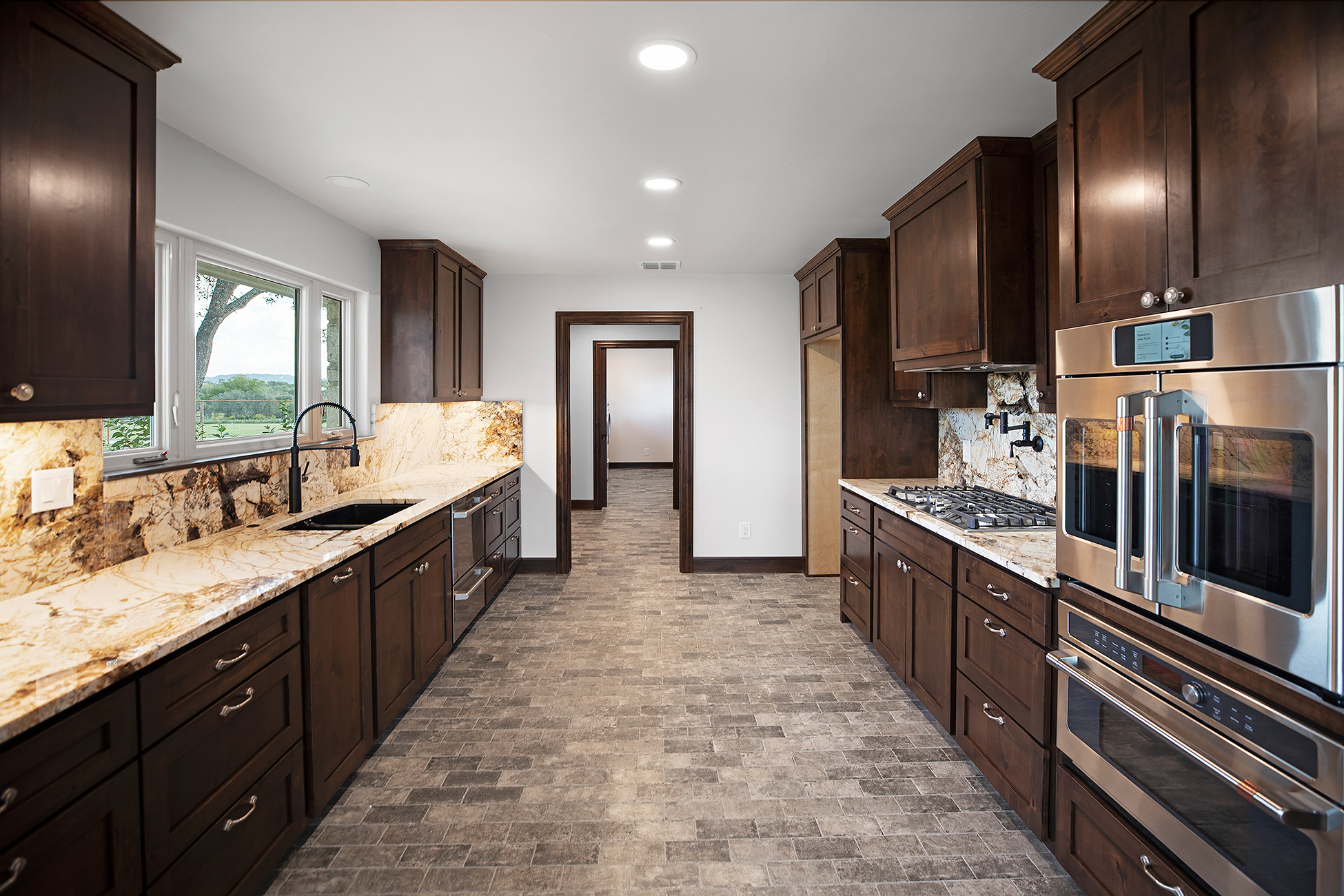 Remodeled kitchen in Terrell Hills, TX with upgraded flooring and clean finish details by Texas Highlands Custom Homes & Remodel.