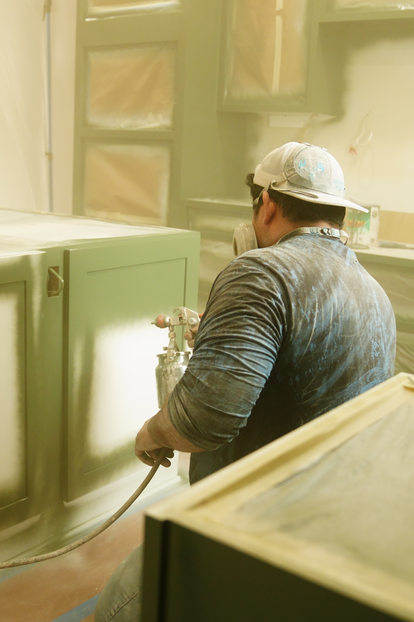 Our Texas Highlands team painting cabinets in a Comfort, Texas home