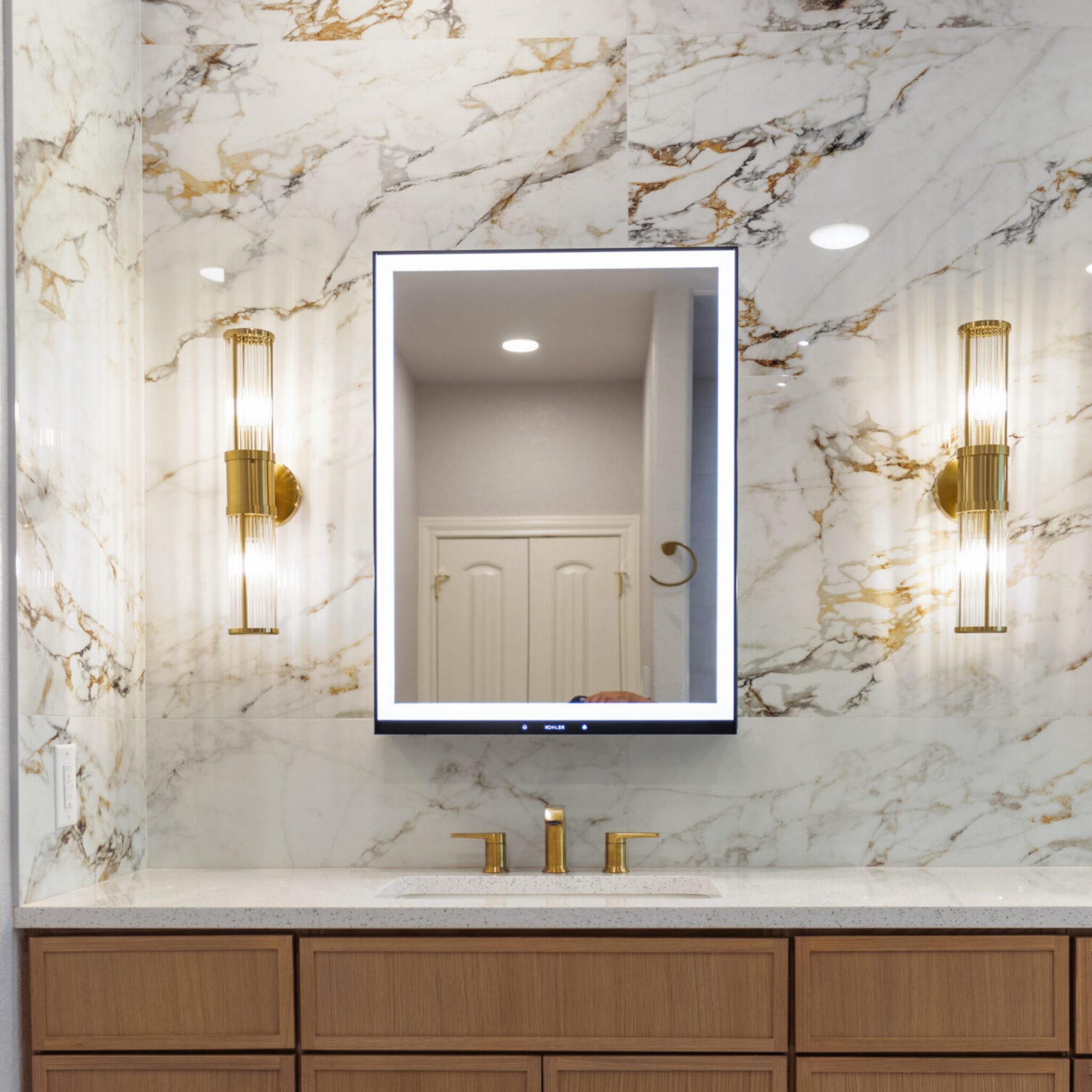 Cavalry Dr Remodel Custom bathroom with warm lighting and quartz countertops