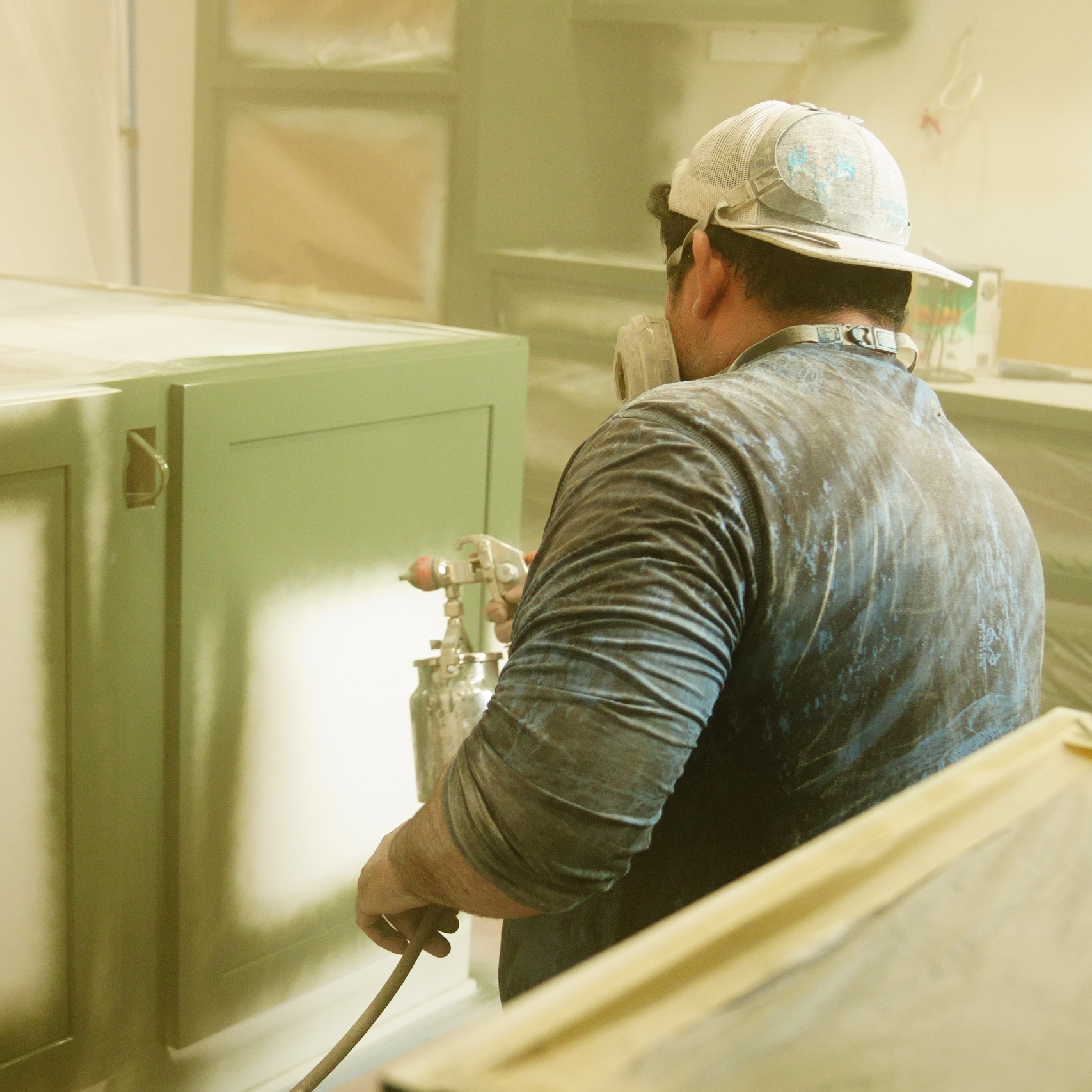 Our Texas Highlands team painting cabinets in a Comfort, Texas home