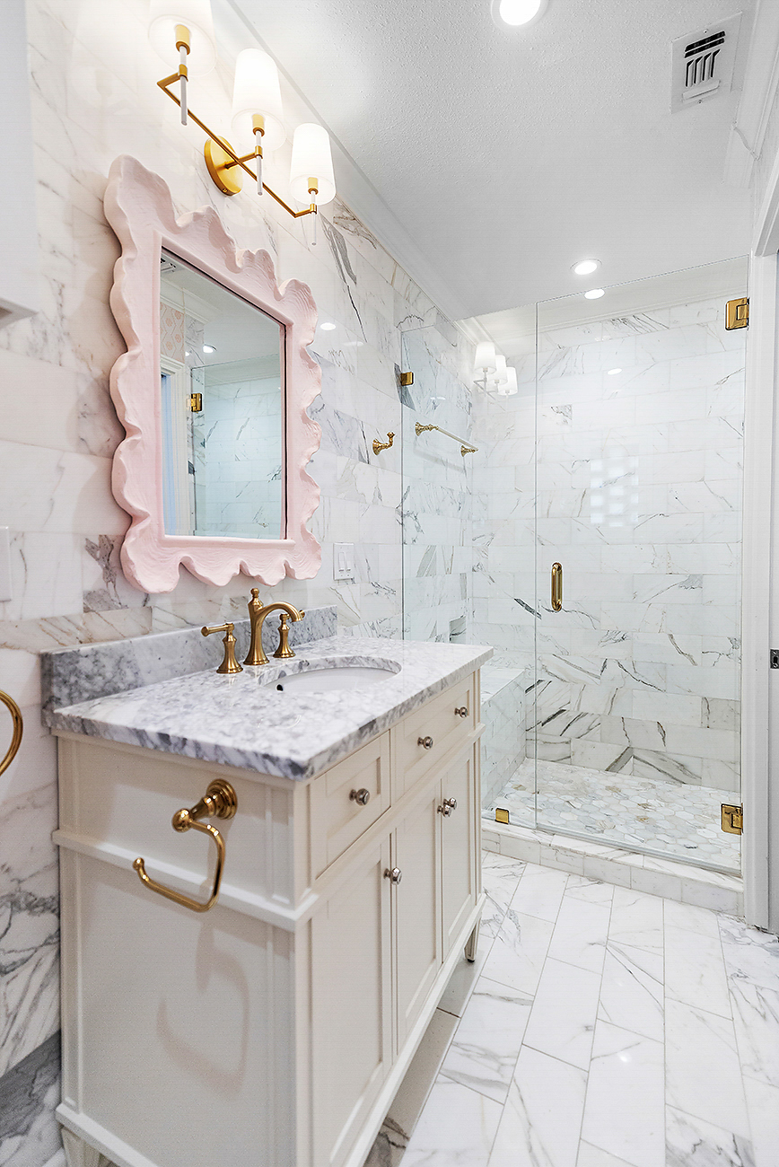 Guest bathroom with marble-look tile in a San Antonio custom home